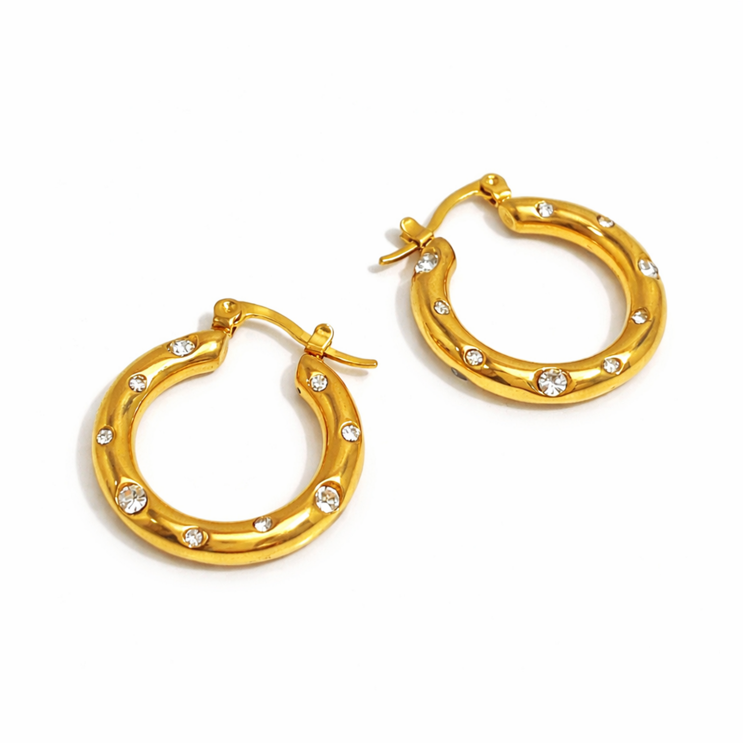 A pair of gold-plated thick hoop earrings for women featuring scattered clear crystals, shown on a white background