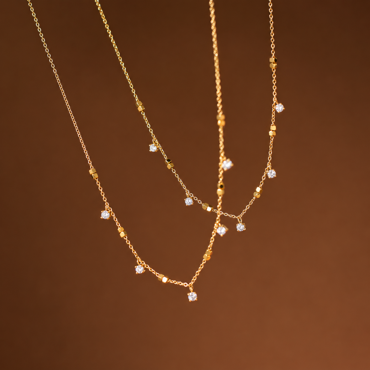 Crystal Station Necklace with clear crystal accents and gold-tone square bead details on a delicate chain.