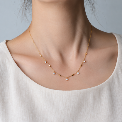 Crystal Station Necklace with clear crystal accents and gold-tone square bead details on a delicate chain, on a model