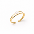 A close view of a modern gold-plated double-band adjustable cuff bracelet for women featuring a single central pearl