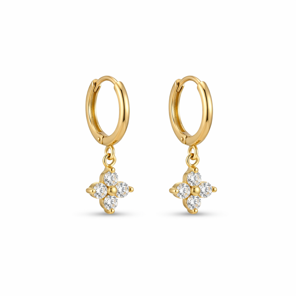 A pair of gold-plated hoop earrings for women featuring a sparkling four-petal crystal clover drop, shown on a white background.