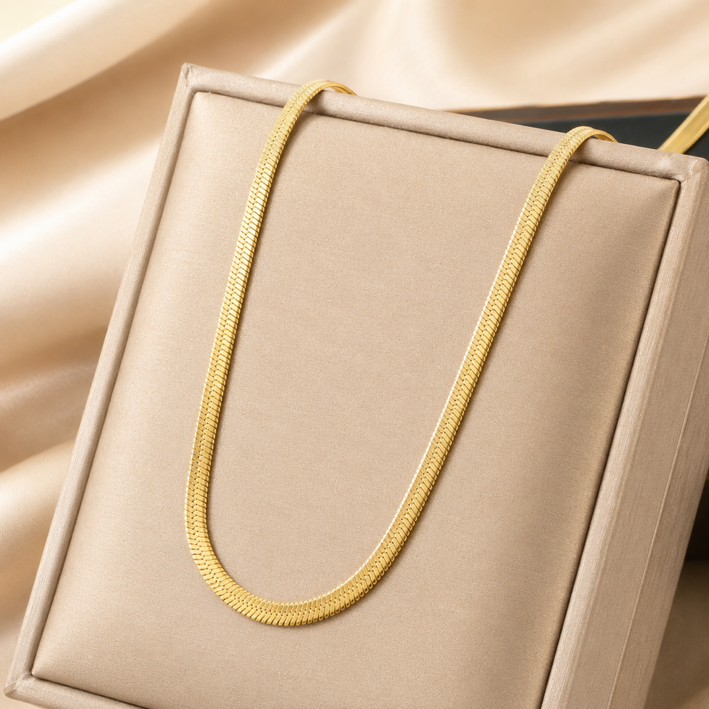 A close-view of a gold-plated stainless steel chain for women featuring a high-shine, liquid-like flat snake chain layout.