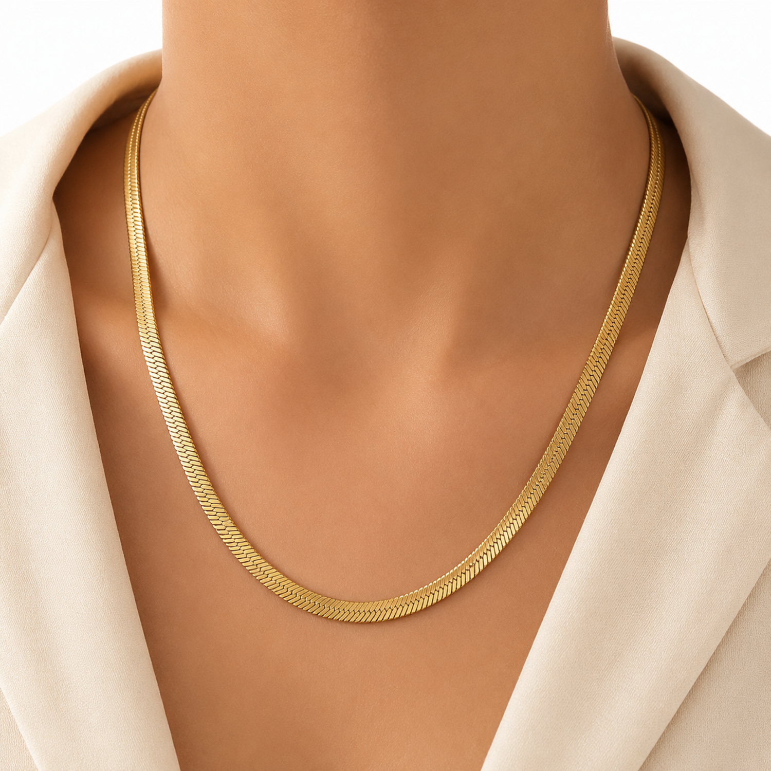 A gold-plated stainless steel chain for women featuring a high-shine, liquid-like flat snake chain layout, on a model