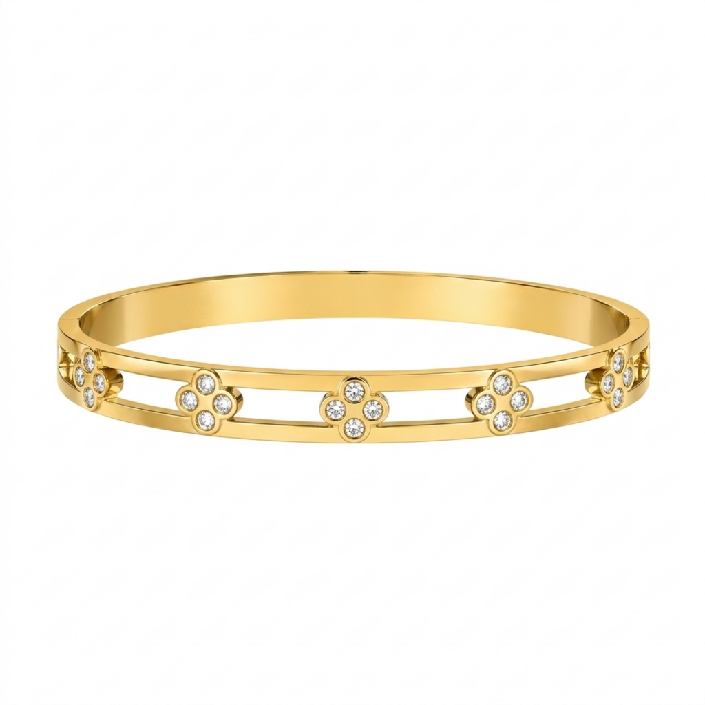 A gold-plated dual-band cuff bangle for women featuring four-petal clover crystal motifs and a secure side-hinge clasp.