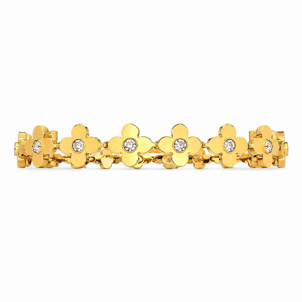 Gold bracelet with floral designs and clear stones on a white background