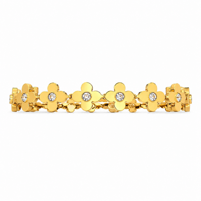 Gold bracelet with floral designs and clear stones on a white background