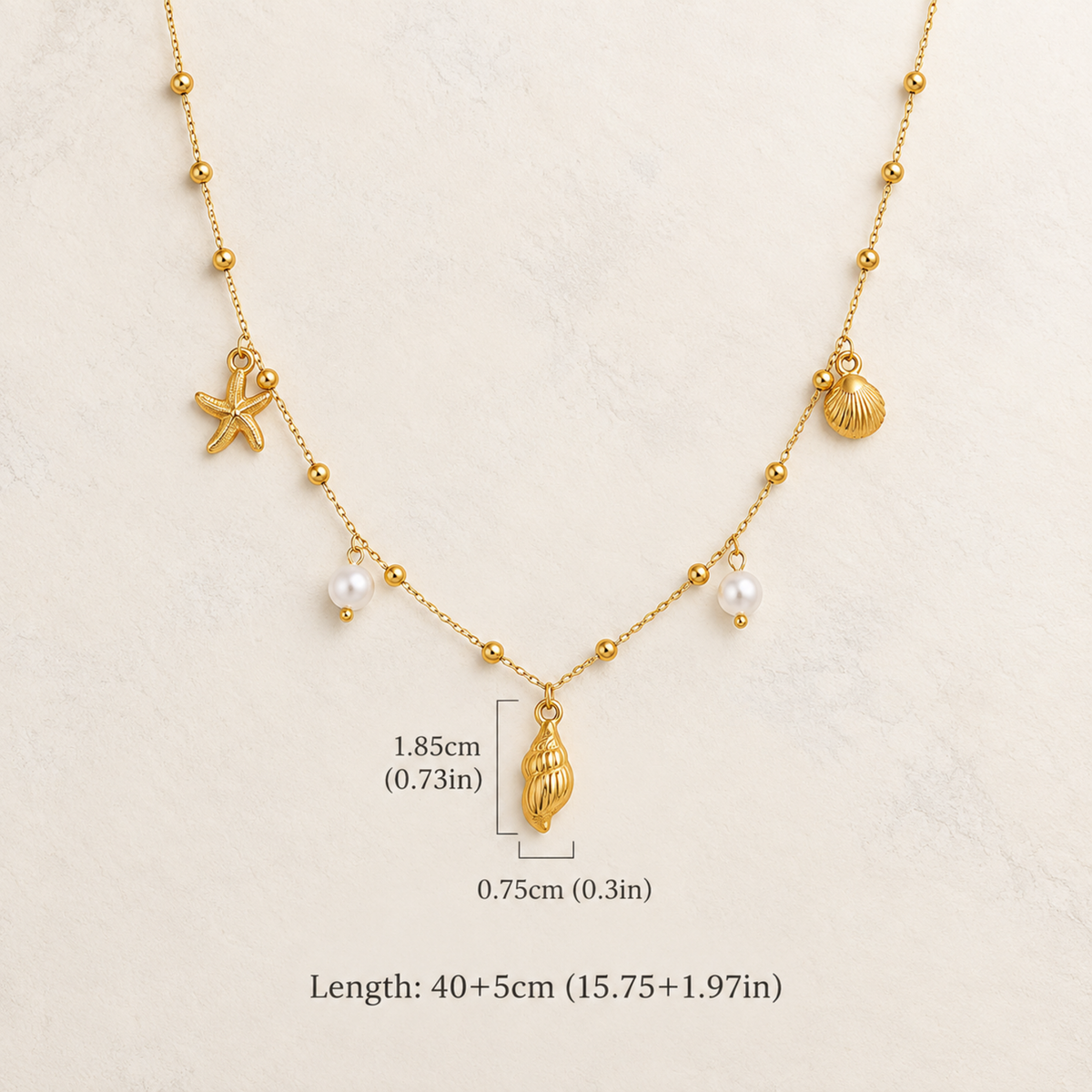 Coralie gold coastal necklace for women with shell, starfish and pearl charms on a delicate chain with dimensions