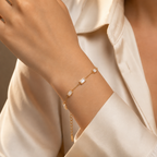 A close-view of a gold-plated stainless steel chain bracelet for women featuring five clear rectangular baguette stones.