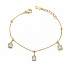 Gold bracelet with square crystal charms on a white background