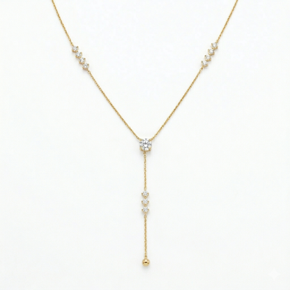 A gold-plated stainless steel chain for women featuring a Y-drop design with multiple crystal accents and a gold bead finish