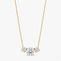 A gold-plated stainless steel chain for women featuring three graduated round-cut crystal stones.