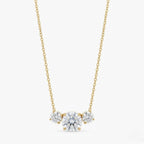 A gold-plated stainless steel chain for women featuring three graduated round-cut crystal stones.