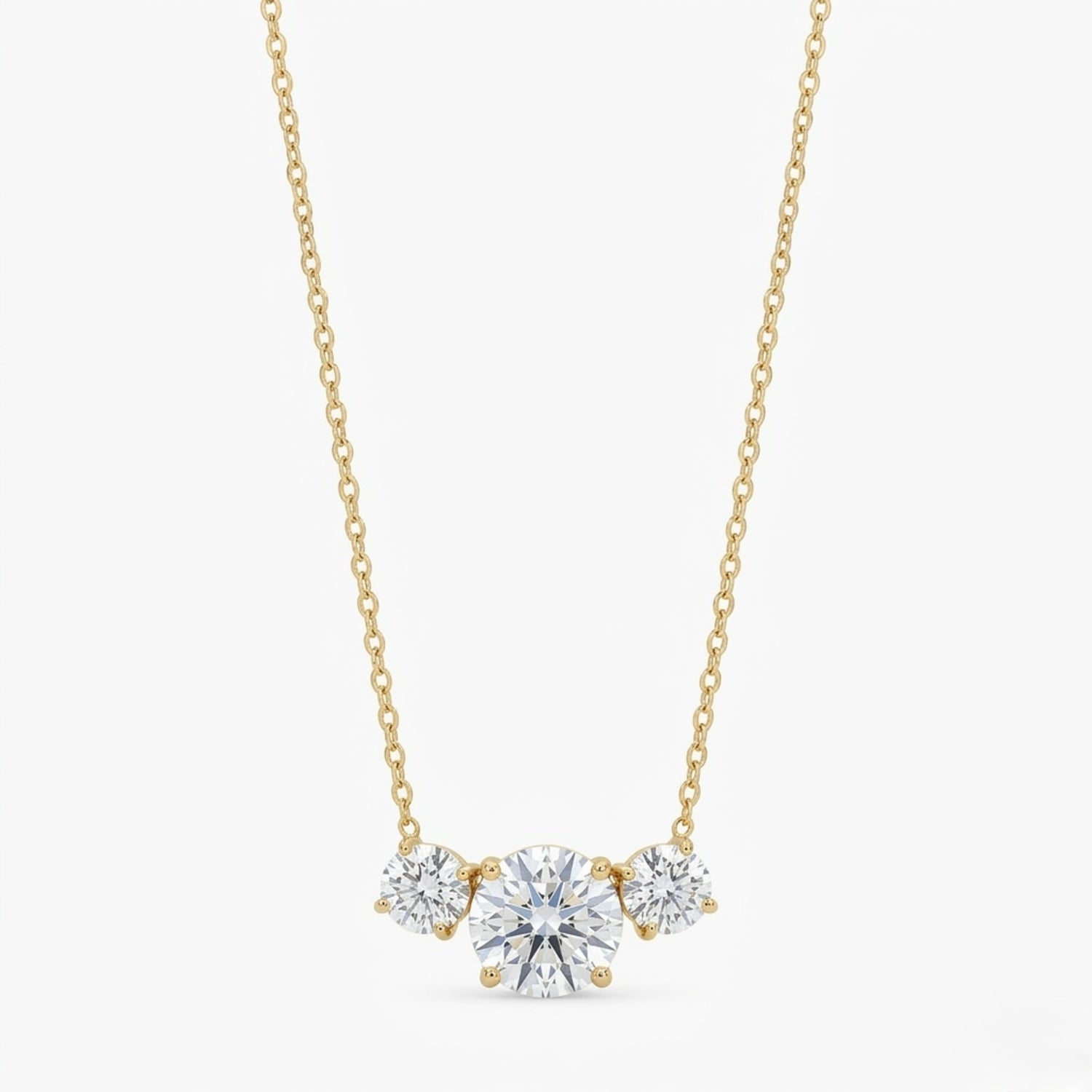 A gold-plated stainless steel chain for women featuring three graduated round-cut crystal stones.