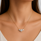 A gold-plated stainless steel chain for women featuring three graduated round-cut crystal stones, shown on a model