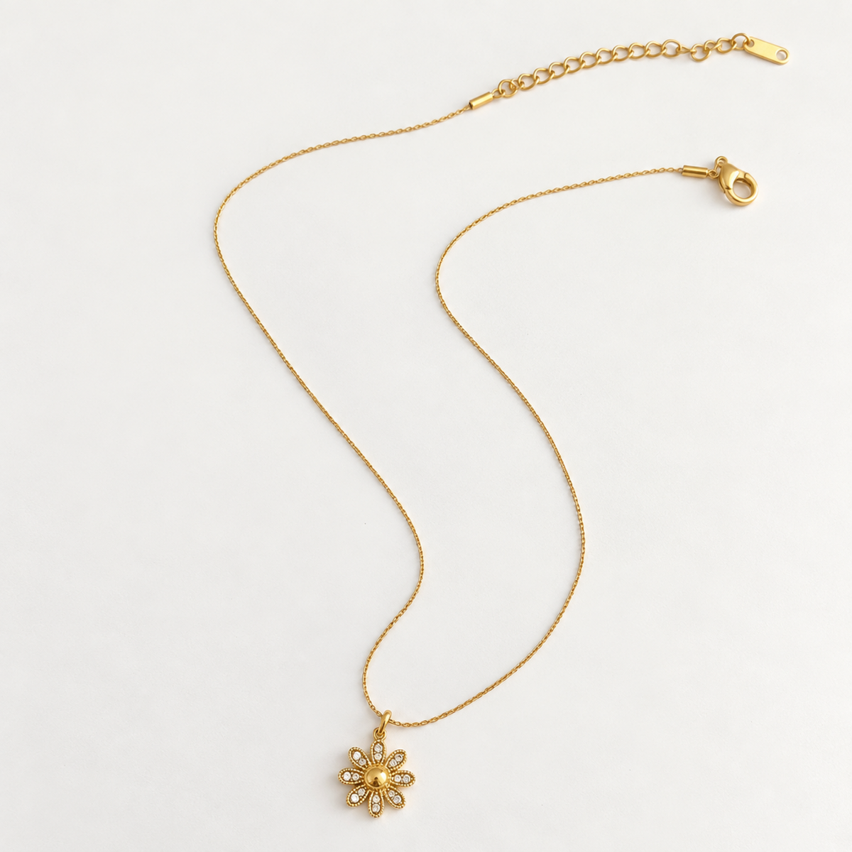 Dahlia Floral Crystal Pendant Necklace with a gold-tone flower pendant and clear crystal accents.