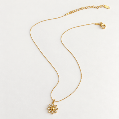 Dahlia Floral Crystal Pendant Necklace with a gold-tone flower pendant and clear crystal accents.