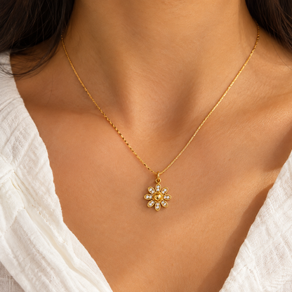 Dahlia Floral Crystal Pendant Necklace with a gold-tone flower pendant and clear crystal accents on a model