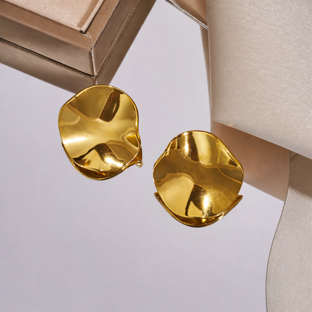 A pair of large, gold-plated sculptural petal stud earrings for women