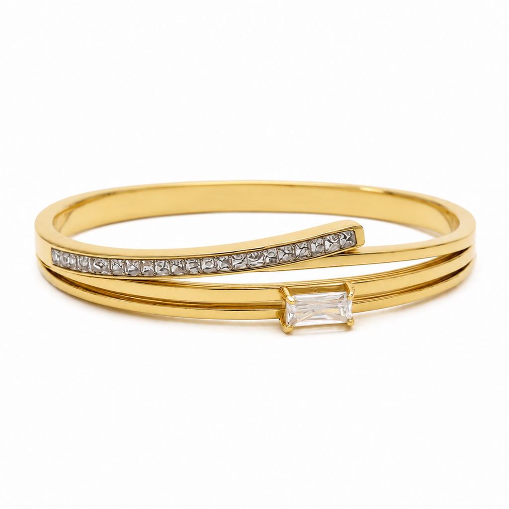 A layered gold-plated bracelet for women featuring a triple-band design with pavé crystals and a central baguette stone.