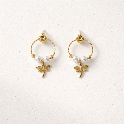 A pair of gold-plated earrings for women featuring a detailed dragonfly charm and three white pearls