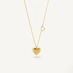 A close-view of a gold-plated stainless steel chain for women featuring a polished 3D heart pendant and a smaller open-heart charm integrated into the side of the chain