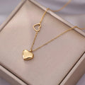A gold-plated stainless steel chain for women featuring a polished 3D heart pendant and a smaller open-heart charm integrated into the side of the chain