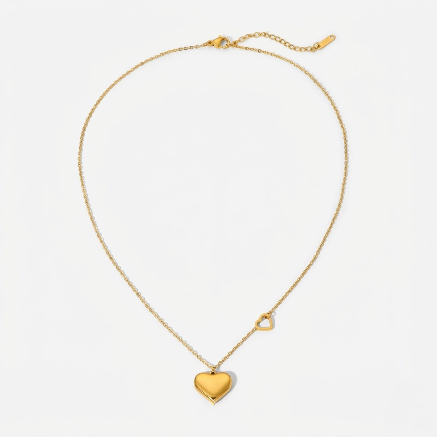 A gold-plated stainless steel chain for women featuring a polished 3D heart pendant and a smaller open-heart charm integrated into the side of the chain