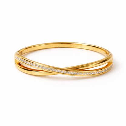 A luxurious gold-plated double-band cross-over bangle for women featuring one polished strand and one strand of brilliant pavé white stones displayed on a white background
