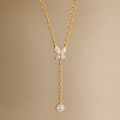 A gold-plated stainless steel chain for women featuring a crystal butterfly lariat design with a plunging drop and solitaire stone