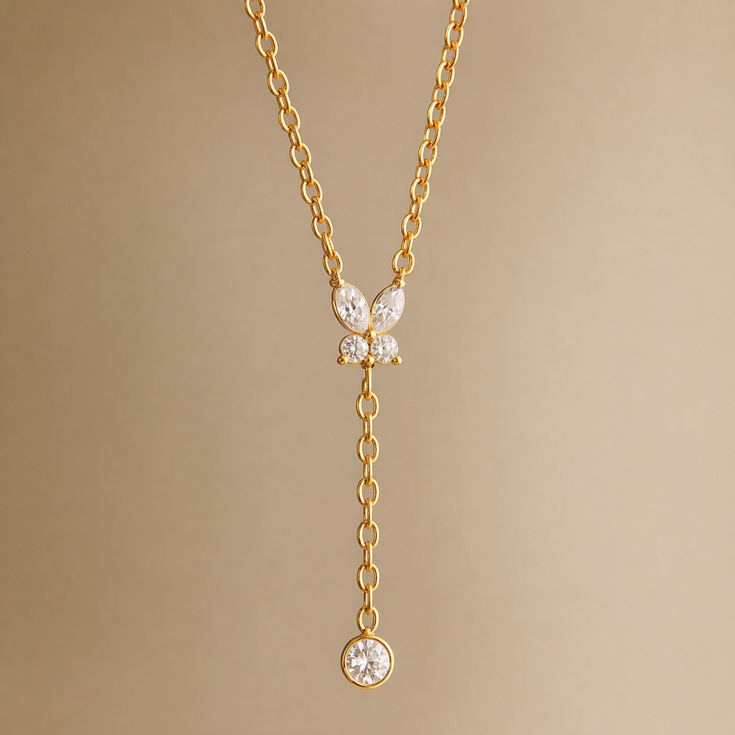 A gold-plated stainless steel chain for women featuring a crystal butterfly lariat design with a plunging drop and solitaire stone