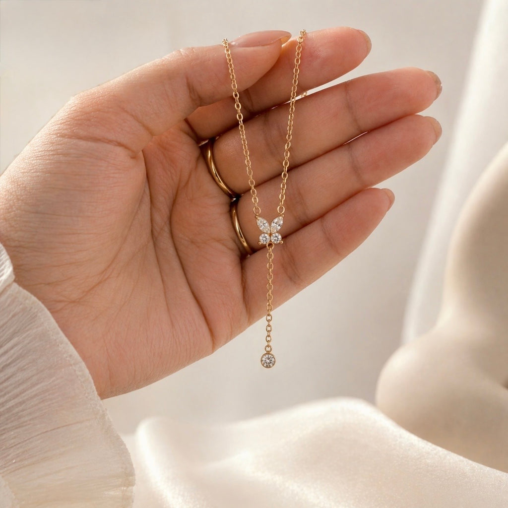 A gold-plated stainless steel chain for women featuring a crystal butterfly lariat design with a plunging drop and solitaire stone