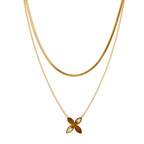 Gold necklace with a flower-shaped pendant on a white background
