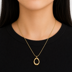 A gold-plated stainless steel chain for women featuring a sleek snake link and a open-oval pendant, shown on a model