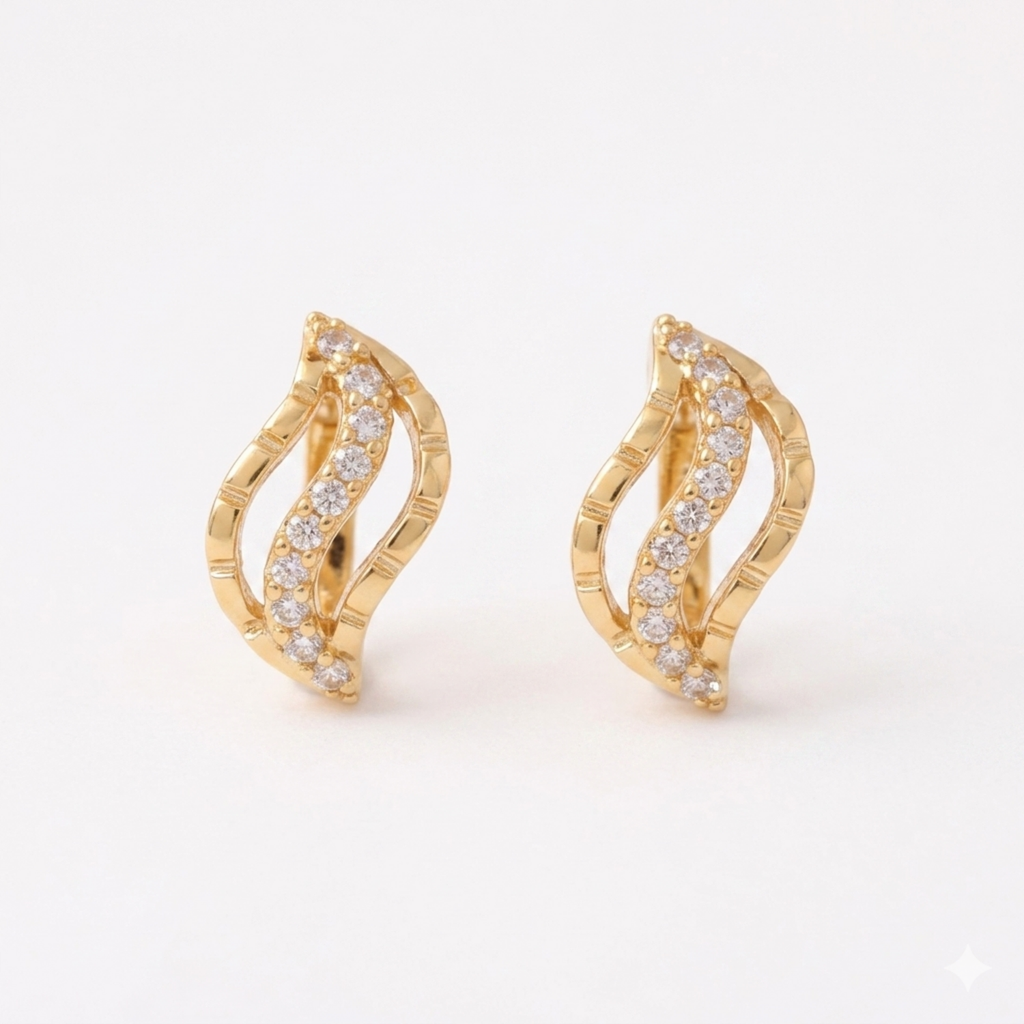A pair of gold-plated wave-shaped huggie hoop earrings for women featuring a curved row of clear crystals, shown on a clean white background.