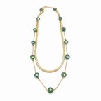 A gold-plated stainless steel chain layered necklace for women featuring a smooth snake chain and a second chain with green faceted heart crystals.