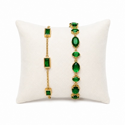 A premium two-piece gold-plated bracelet stack for women featuring the Emerald Horizon Baguette Bracelet and a matching faceted emerald green oval crystal chain bracelet