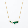 A gold-plated stainless steel chain for women featuring an asymmetrical pendant bar set with various emerald green and white crystal stones