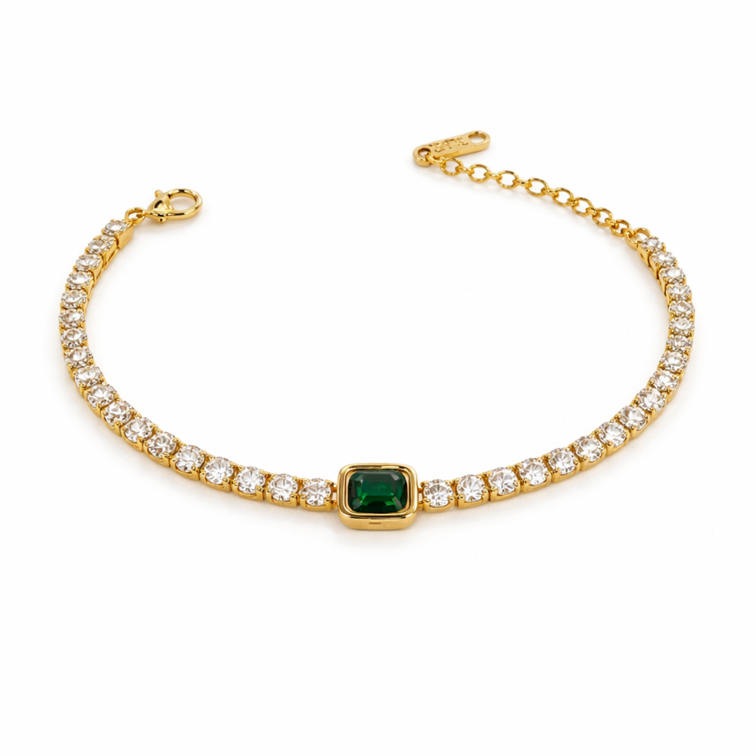 A gold-plated tennis chain bracelet for women featuring a row of clear crystals and a central emerald-green stone, shown on a clean white background.