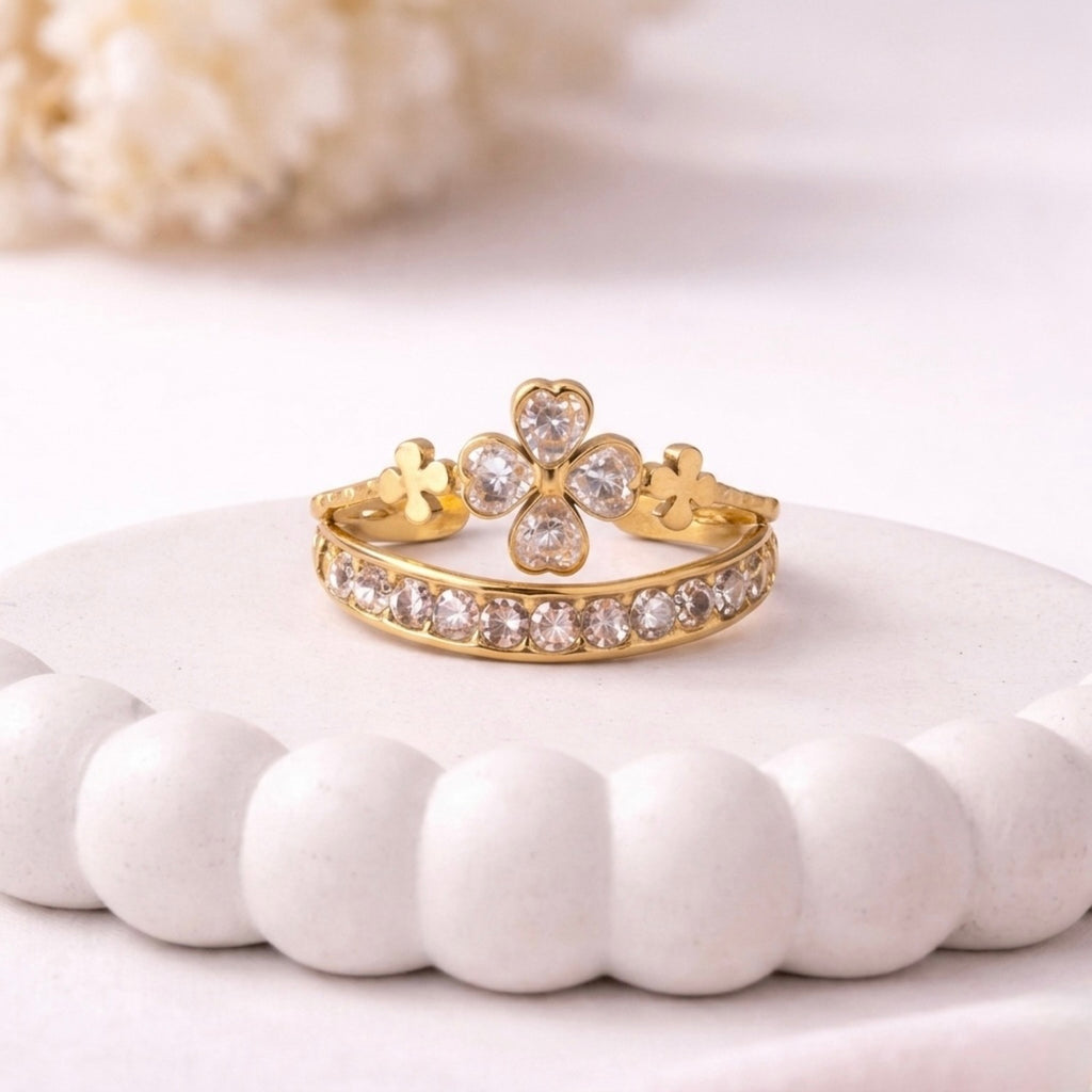 A luxurious gold plated adjustable ring for women featuring four-leaf clover motif eternity band displayed on a white surface
