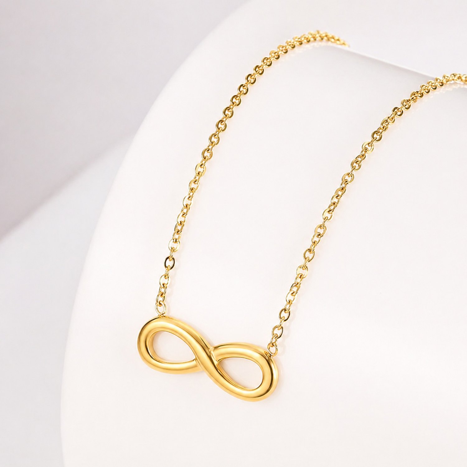 A close-view of a gold-plated stainless steel chain for women featuring a infinity symbol pendant.