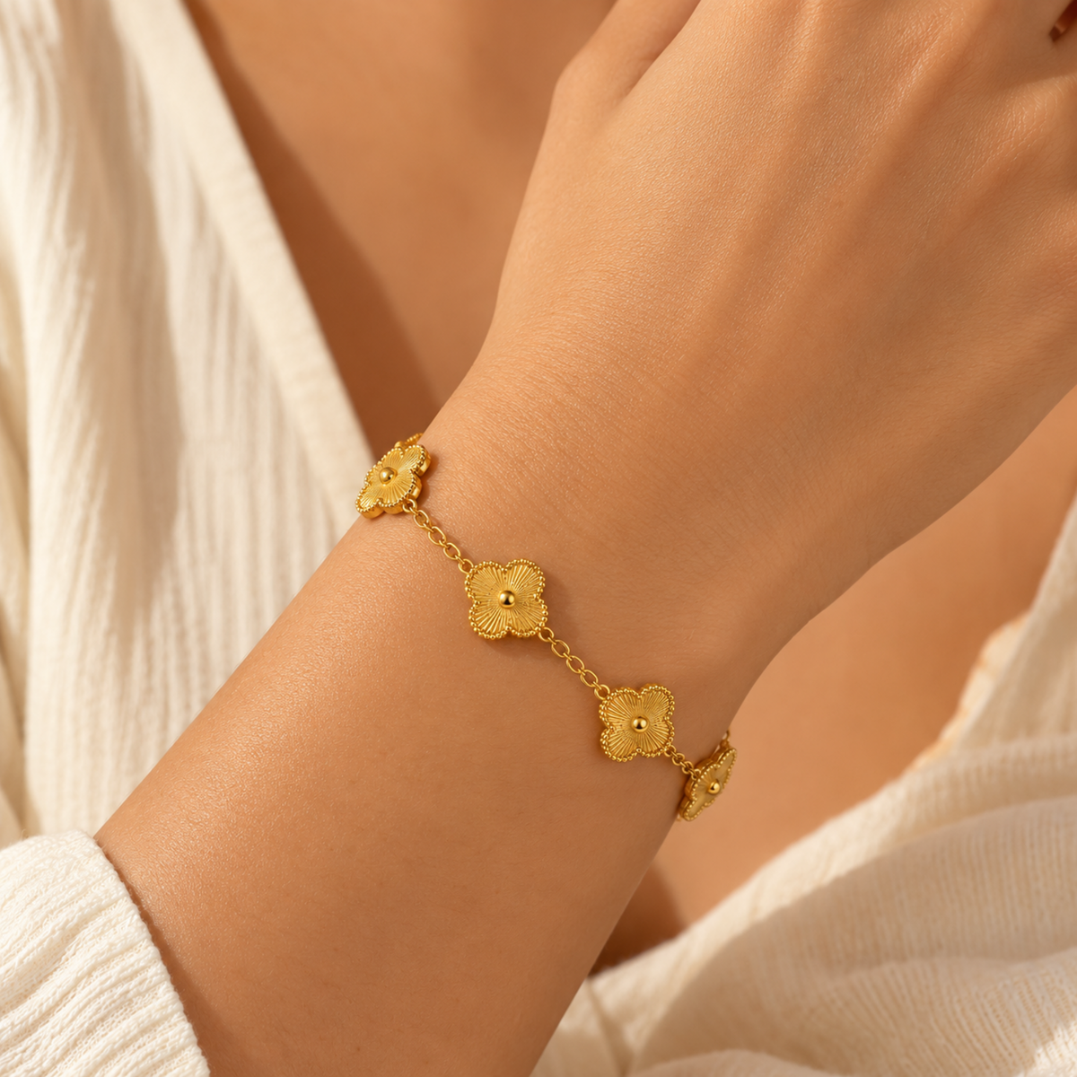 Chain Bracelet with five detailed floral charms on a gold-tone link chain on a model