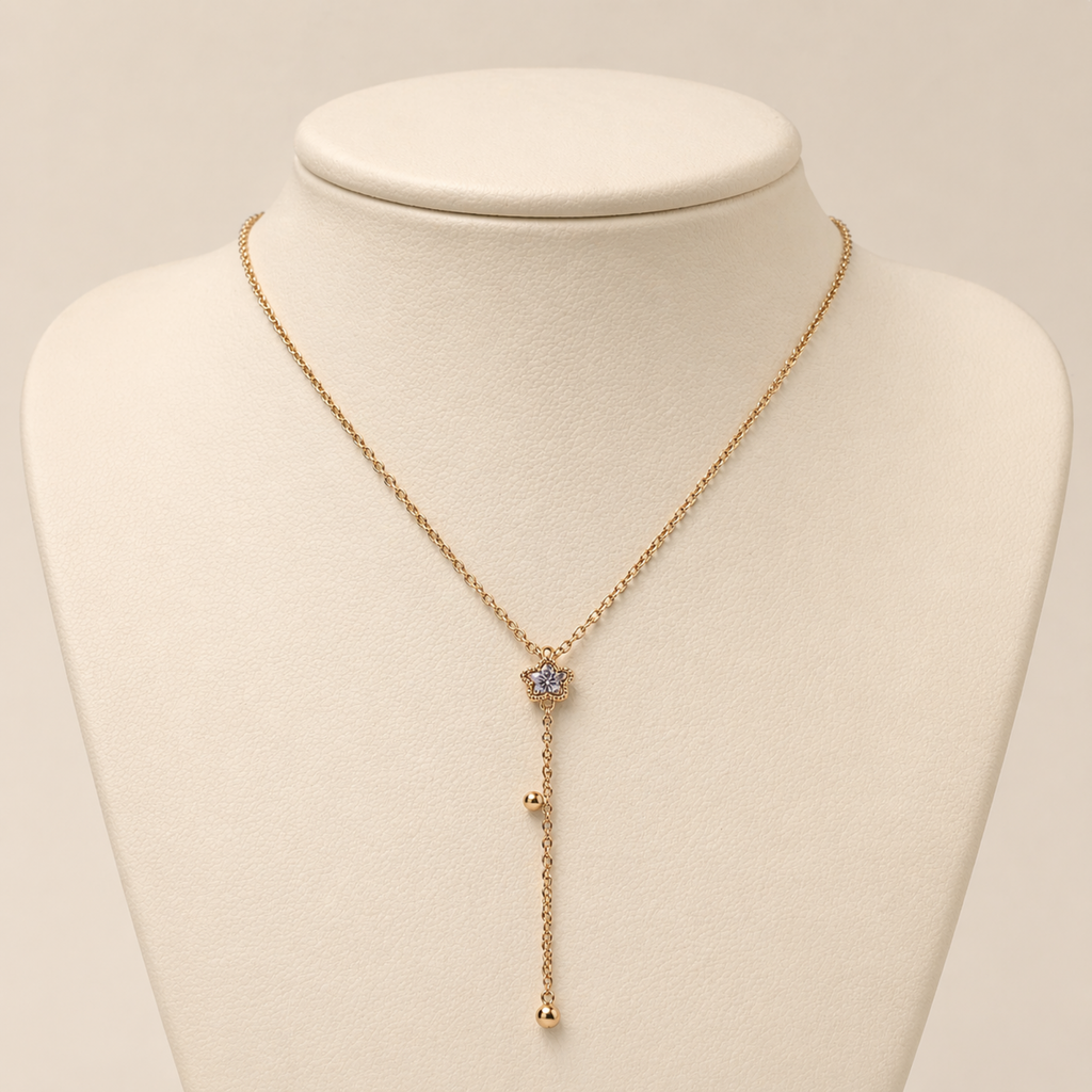 A gold-plated stainless steel Y-shaped necklace for women featuring a small crystal flower pendant and a dangling chain with gold beads