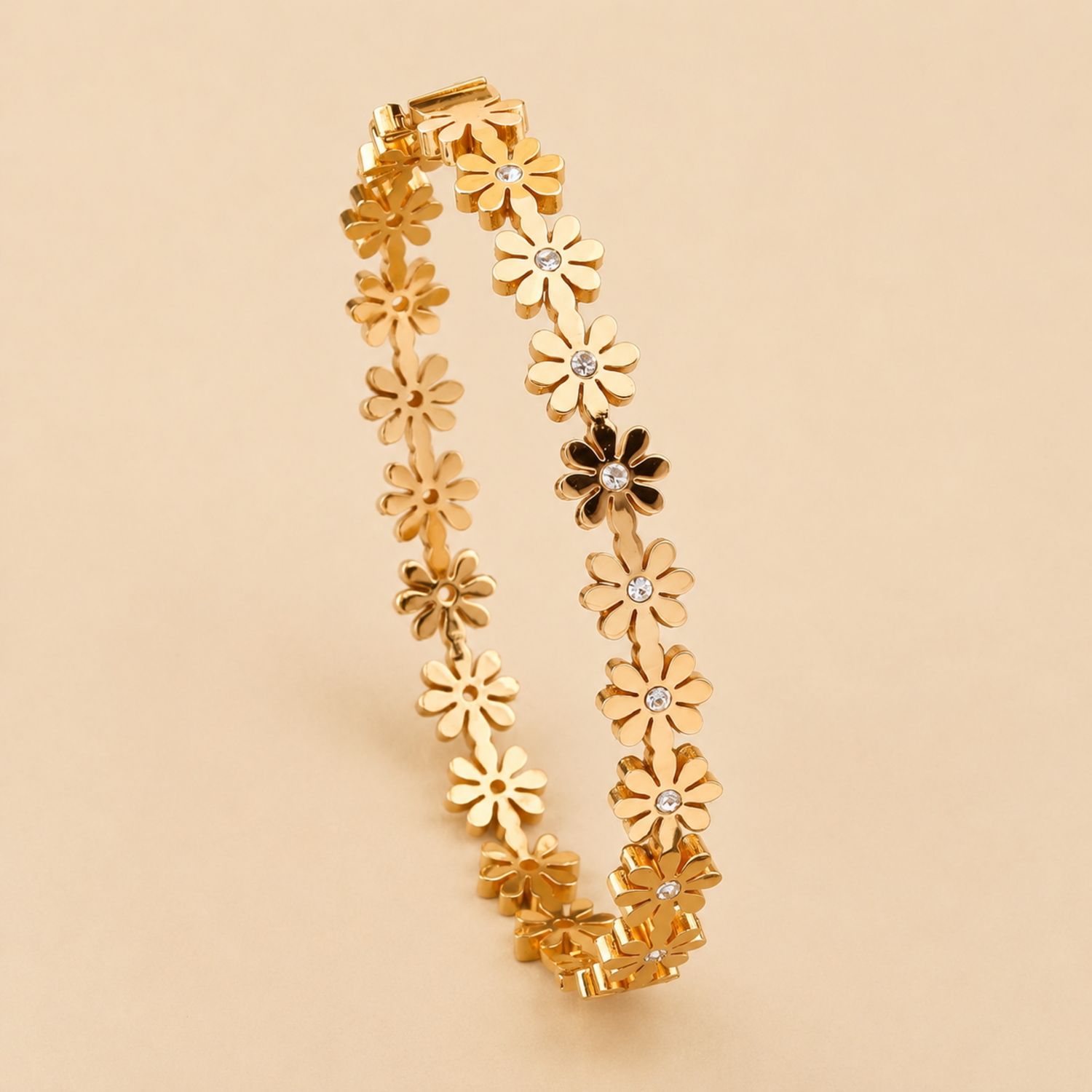 A gold-plated bangle for women featuring an intricate floral openwork design and a secure side clasp