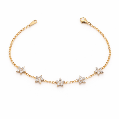 A delicate gold-plated chain bracelet for women featuring five star-shaped floral crystal stations, shown on a clean white background