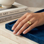 Adjustable dome ring for women featuring etched starbursts and colorful blue, pink, and clear stones on a model hand