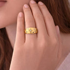 A close view of an adjustable dome ring for women featuring etched starbursts and colorful blue, pink, and clear stones