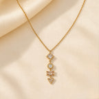 A gold-plated stainless steel chain for women featuring a vertical pendant with four different geometric crystal shapes