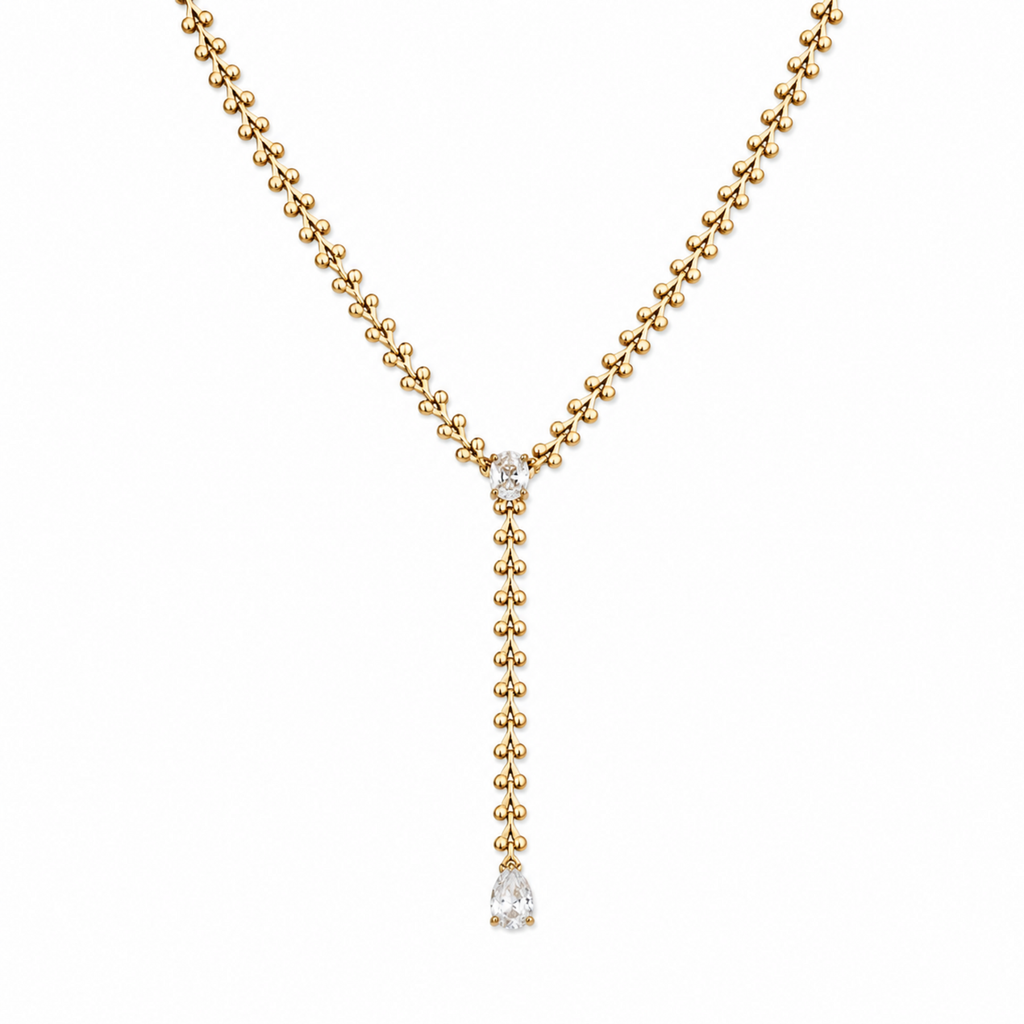 A gold-plated stainless steel chain for women in a Y-drop lariat style featuring a vine-like beaded link and teardrop crystal