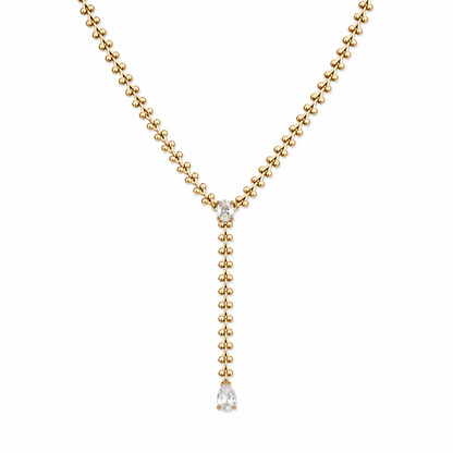 A gold-plated stainless steel chain for women in a Y-drop lariat style featuring a vine-like beaded link and teardrop crystal