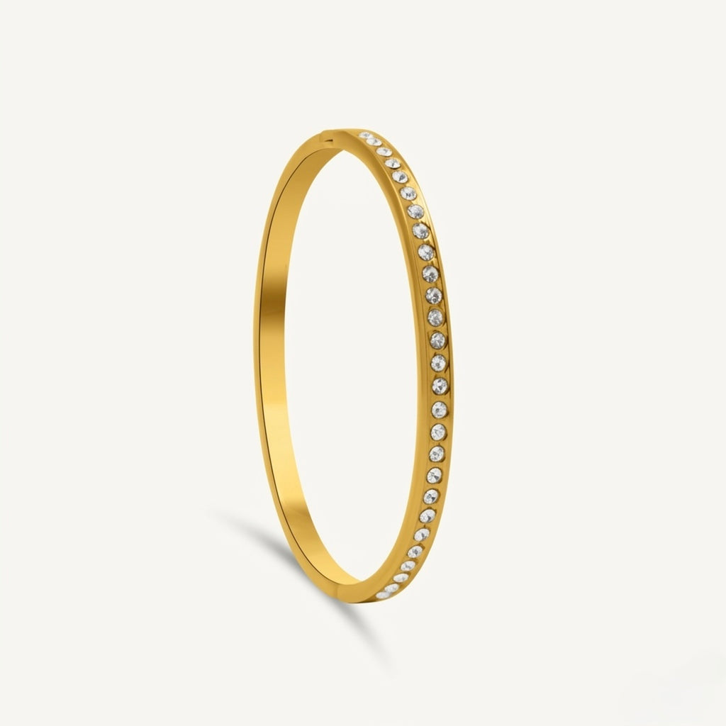 A gold-plated eternity bracelet for women featuring a continuous row of round-cut crystals and a secure side-clasp.